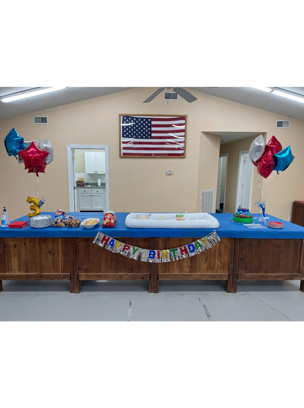 Community center hall decorated with balloons for a celebration
